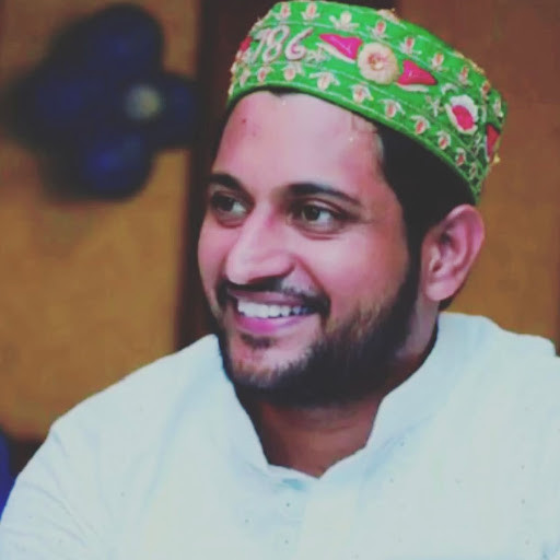 Sai Ji smiling in traditional cap